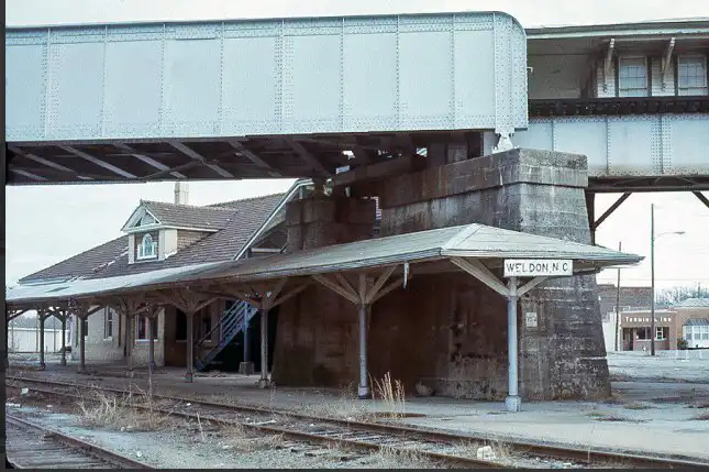 Vintage image of Weldon NC train station, the first railroad hub in the South, with historic town buildings nearby. #WeldonNC #TrainStationHistory #HistoricWeldon #FirstRailroadHub